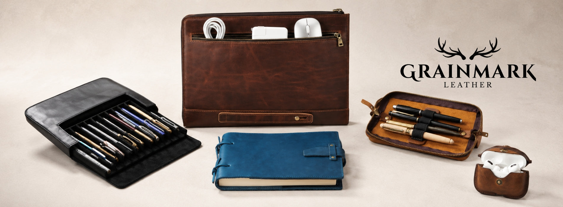 Leather gifts for writers arranged on a clean studio background with notebooks, pen cases, tech sleeves, and leather accessories.